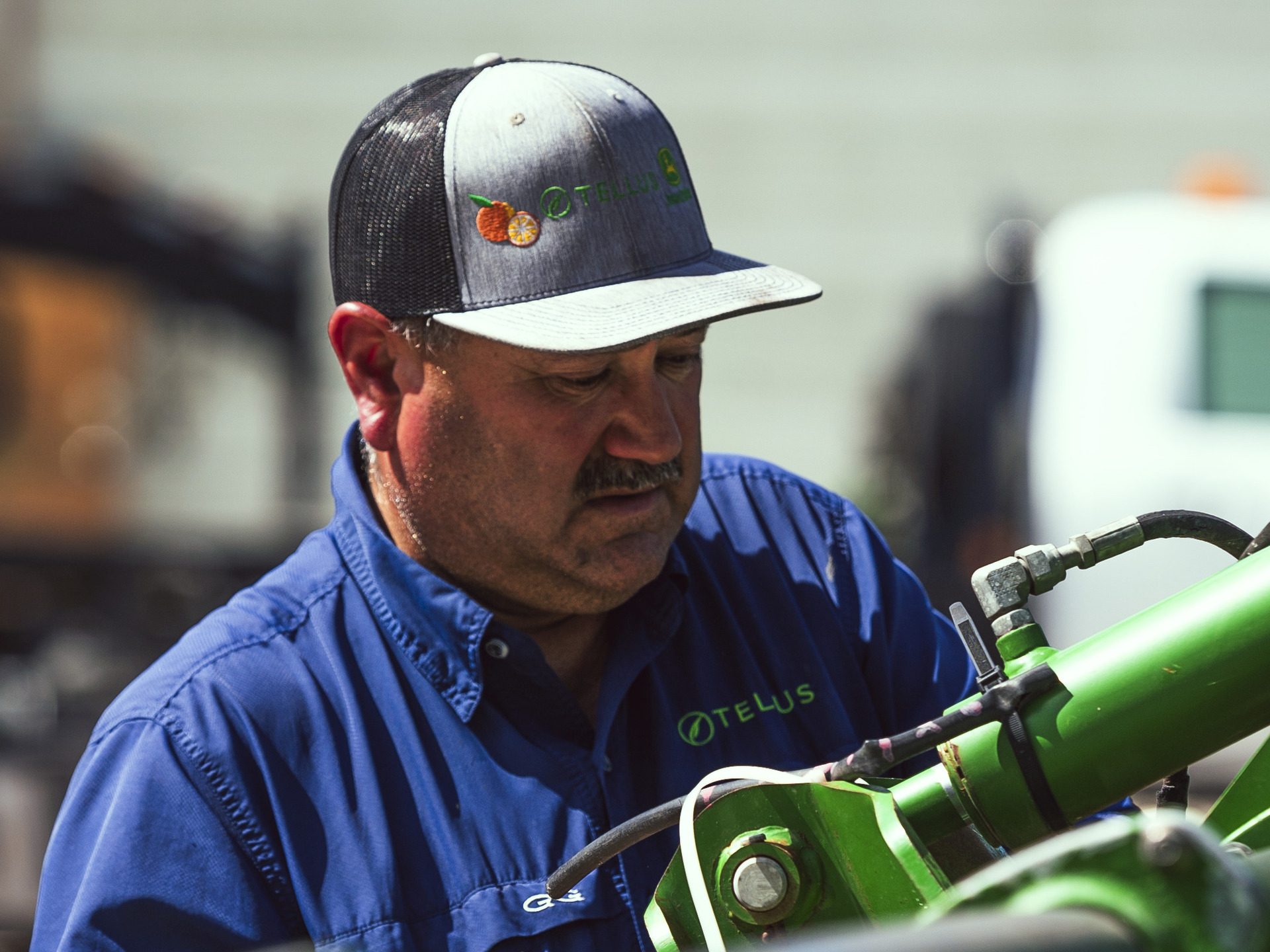 A worker at Tellus Equipment works on a customer's John Deere tractor.
