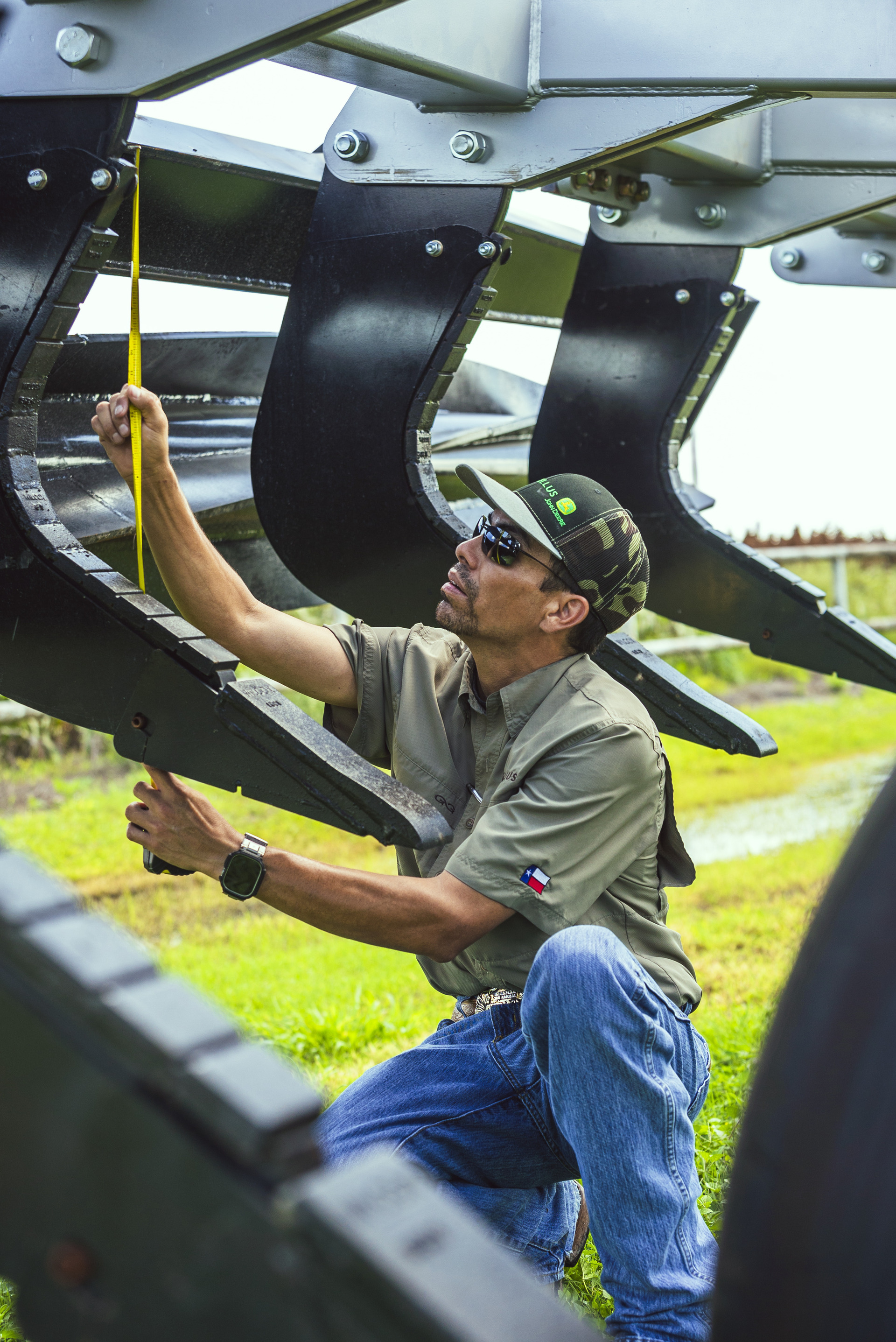 A worker at Tellus Equipment in Texas works on a combine.