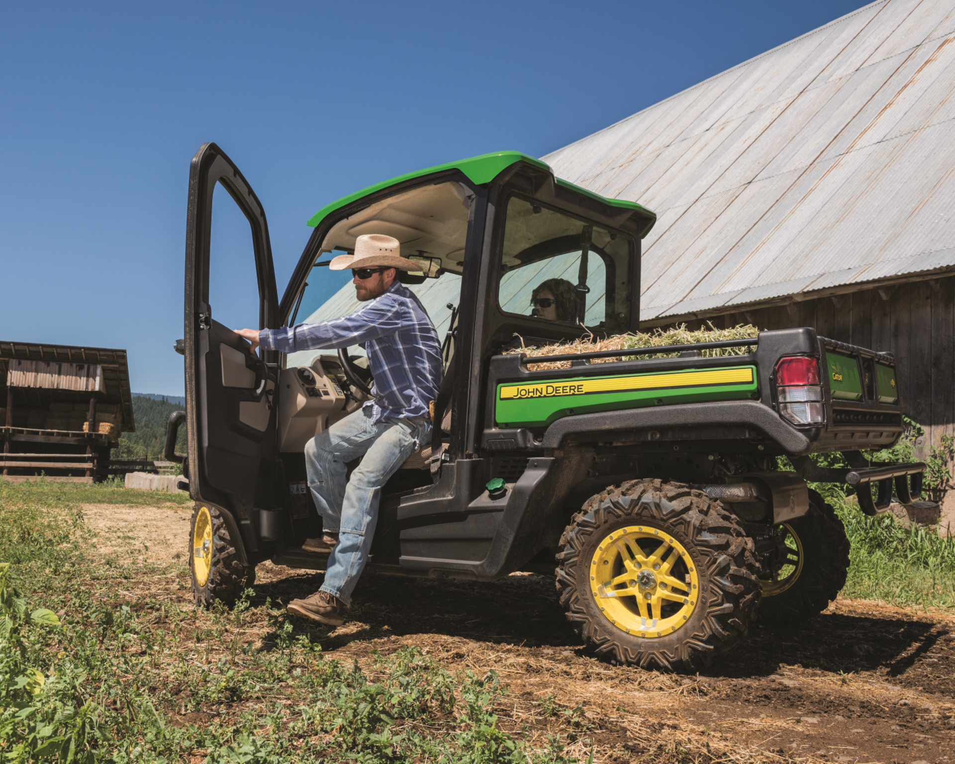 A man operates a John Deere used Gator on a farm.
