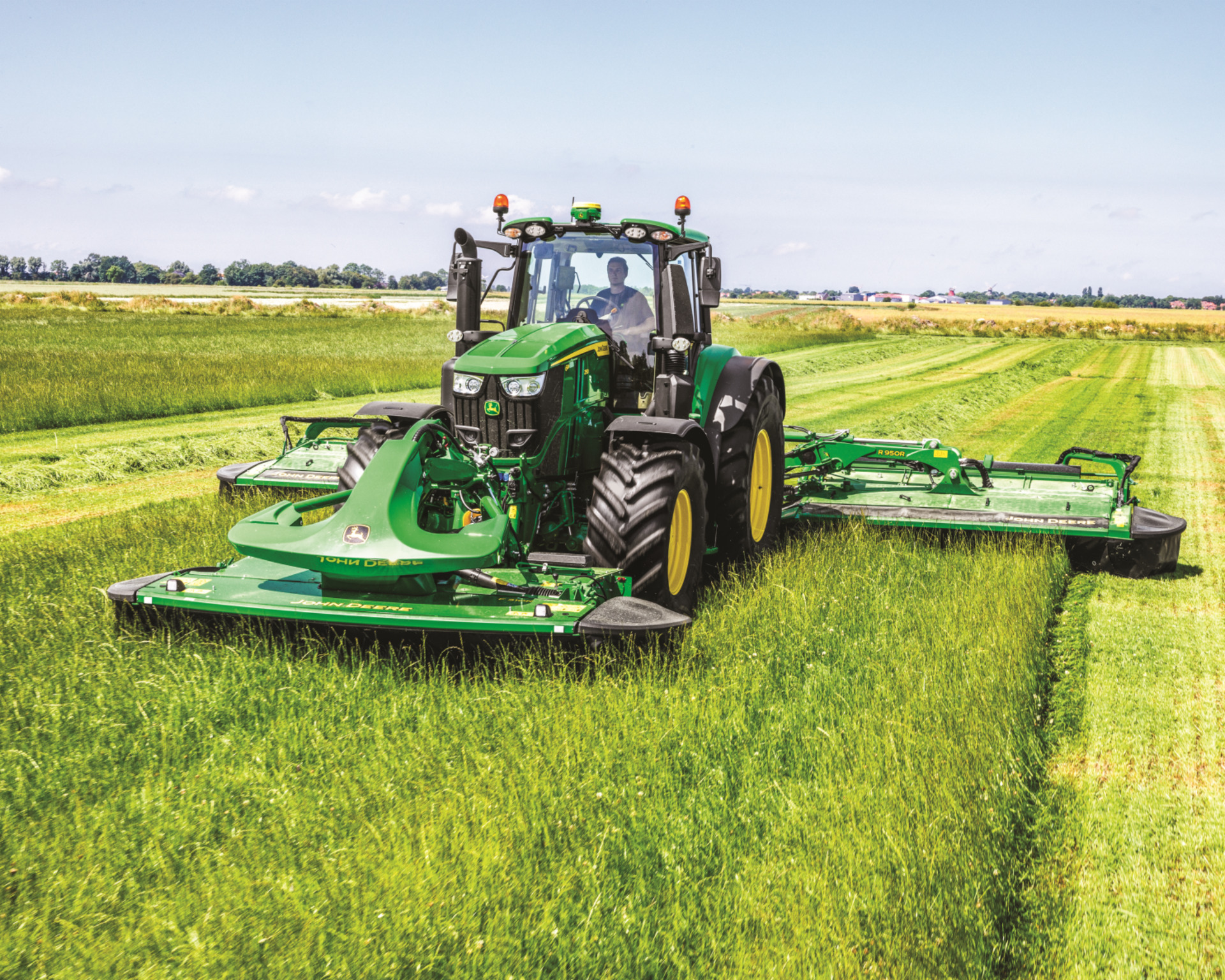 An operator of a used tractor in Texas uses a rotary cutter to mow down a field.