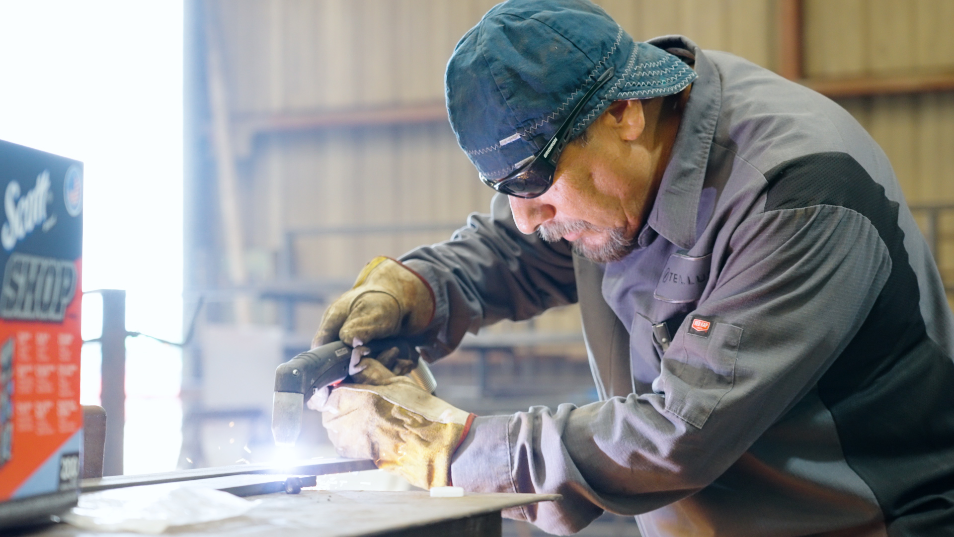A service technician welds a piece of metal at Tellus Equipment Solutions shop in Texas.