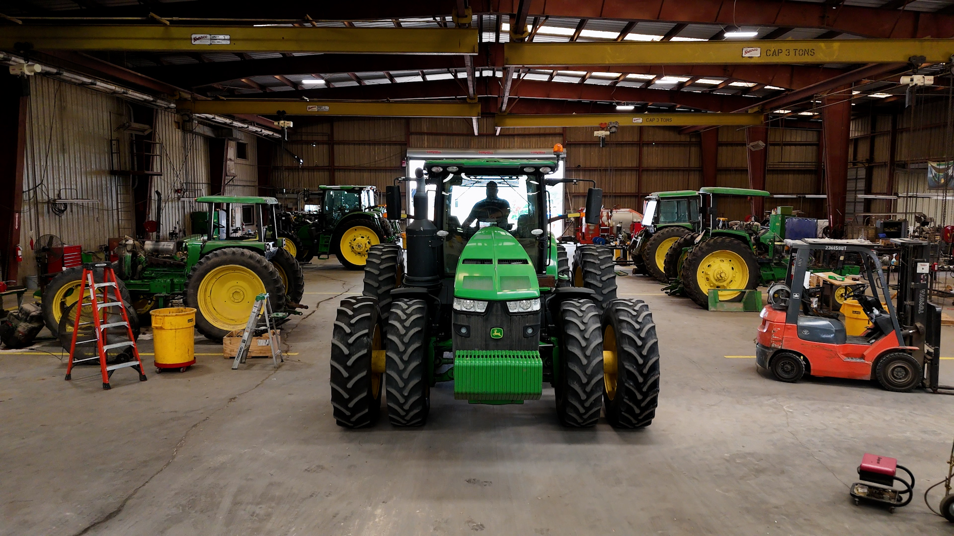 A John Deere tractor sits inside a shed to protect it from Texas storms.