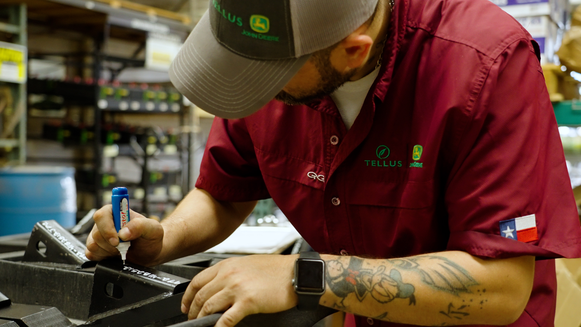 A Tellus worker inspects a John Deere machine before the season starts.